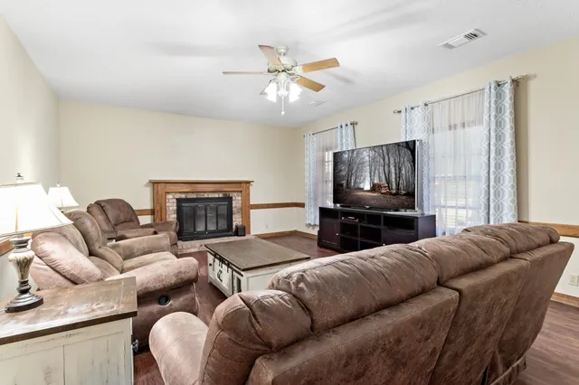 a living room with furniture and a fireplace
