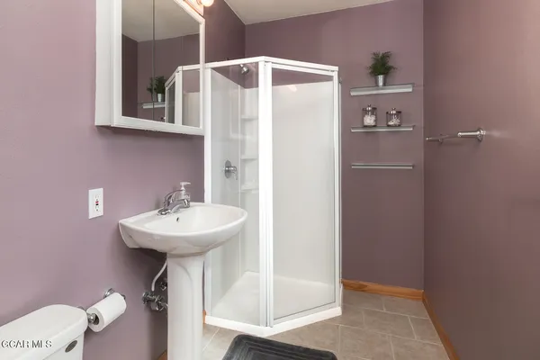 a bathroom with a sink a mirror and shower