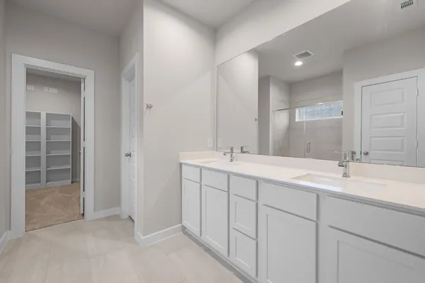 a bathroom with a sink double vanity and a mirror