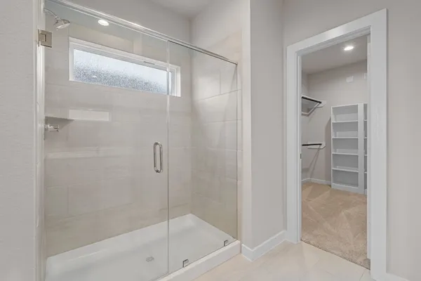 a bathroom with a bathtub and a glass shower