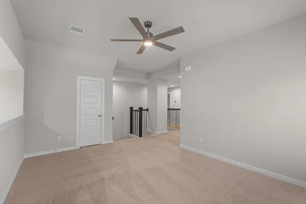 a view of a livingroom with a ceiling fan and window