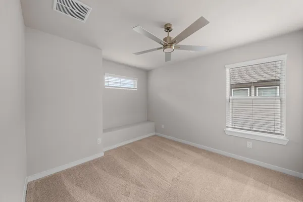 a view of a big room with wooden floor closet and windows
