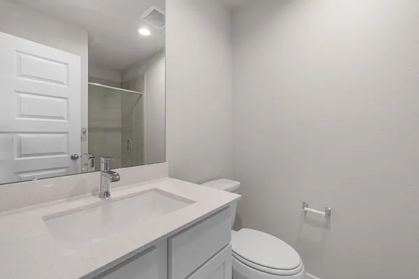 a bathroom with a sink a toilet and vanity