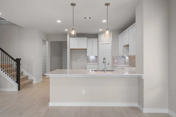 a large kitchen with kitchen island a sink stainless steel appliances and cabinets