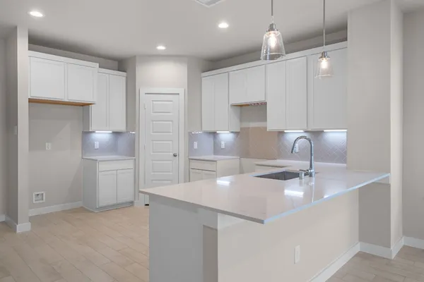 a kitchen with kitchen island a sink stainless steel appliances and cabinets