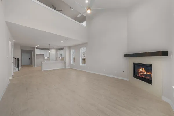 an empty room with a fireplace and window