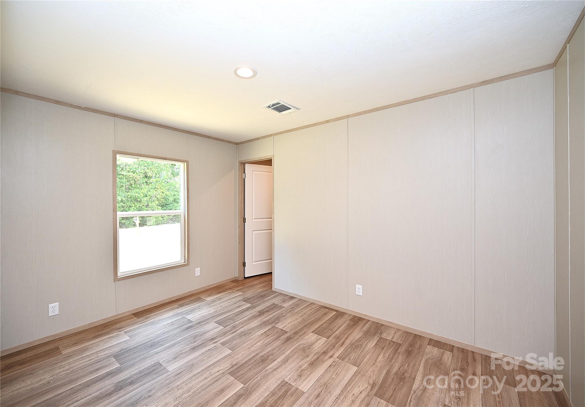 1213 Renno Road Clinton, SC 29325 - Photo 15 of 17 a view of an empty room with wooden floor and a window