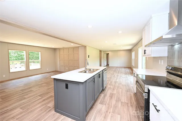 a view of a kitchen with a sink and dishwasher in it