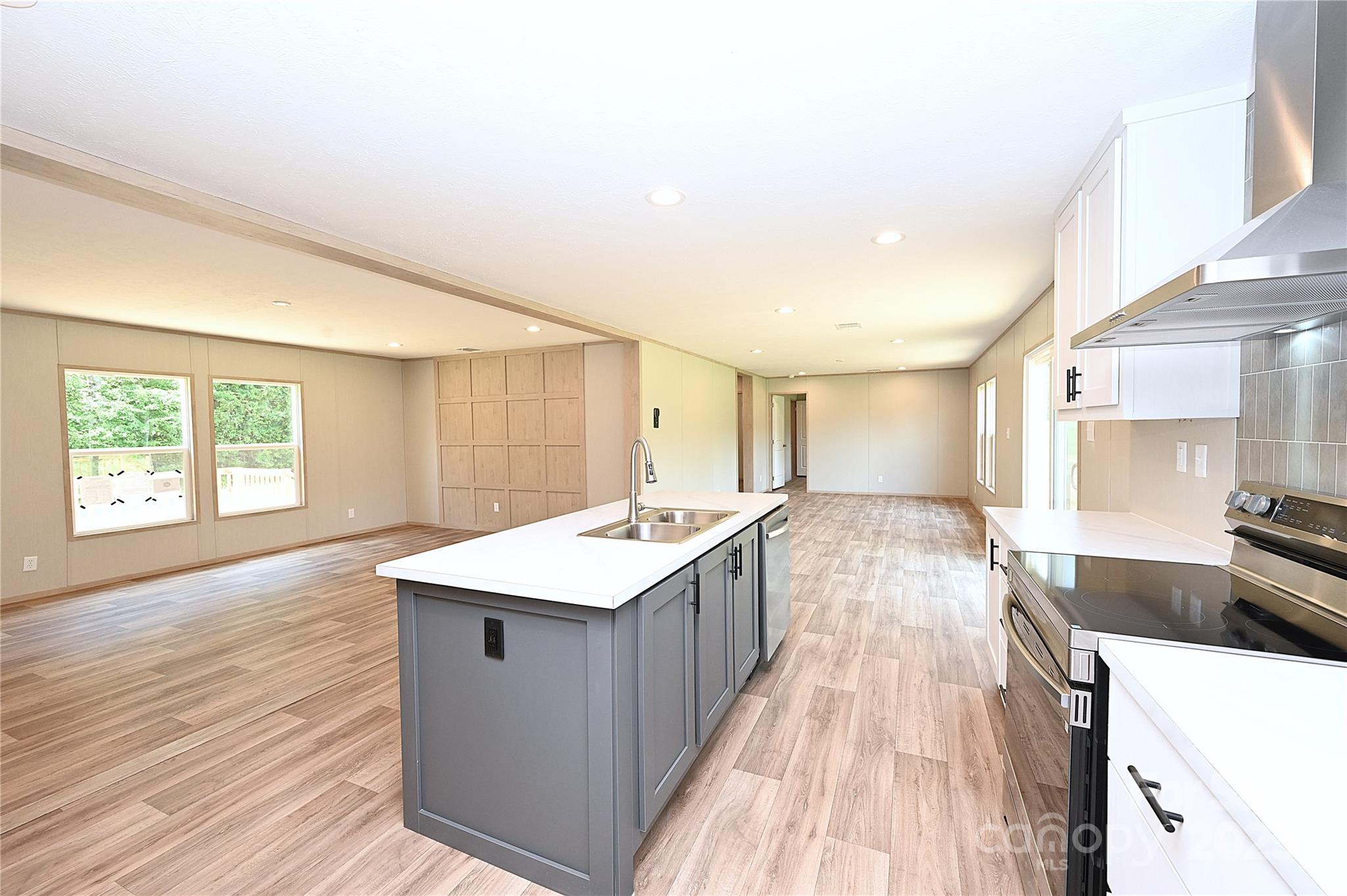 1213 Renno Road Clinton, SC 29325 - Photo 5 of 17 a large kitchen with kitchen island a sink stove and wooden floor