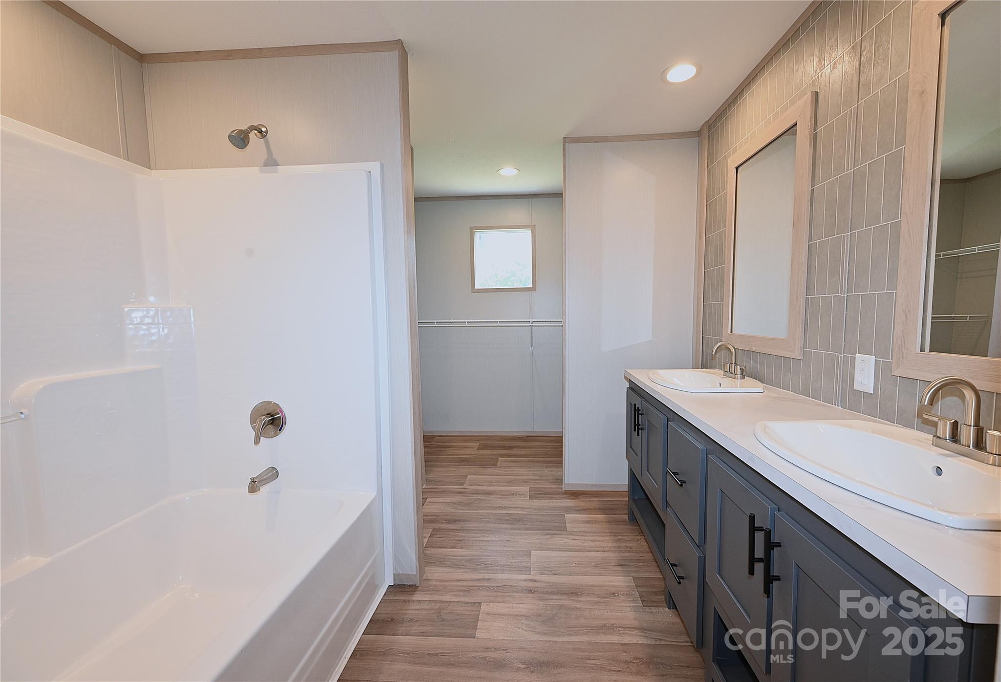 1213 Renno Road Clinton, SC 29325 - Photo 8 of 17 a bathroom with a tub sink shower and two mirror