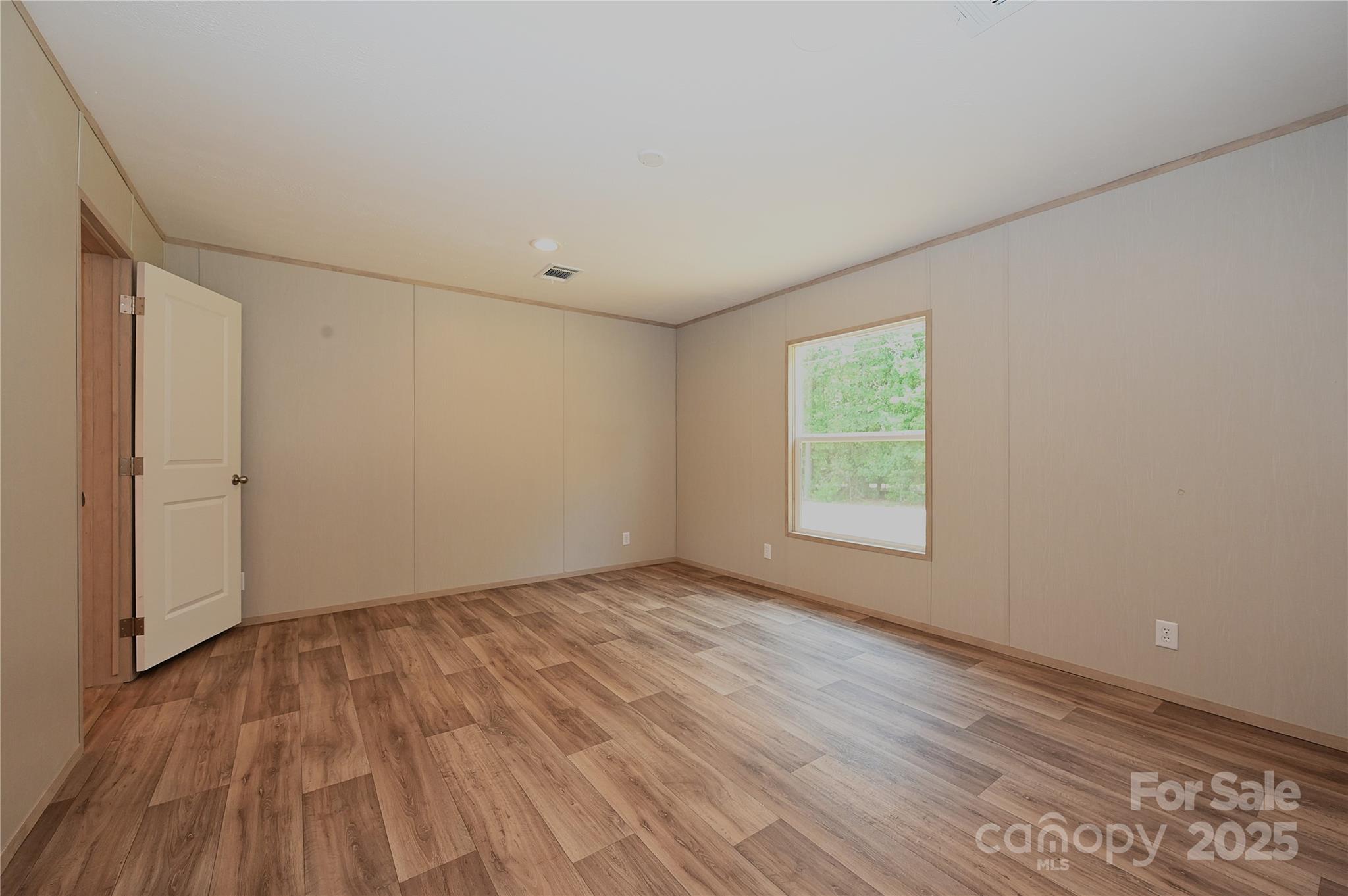 1213 Renno Road Clinton, SC 29325 - Photo 9 of 17 a view of an empty room with wooden floor and a window