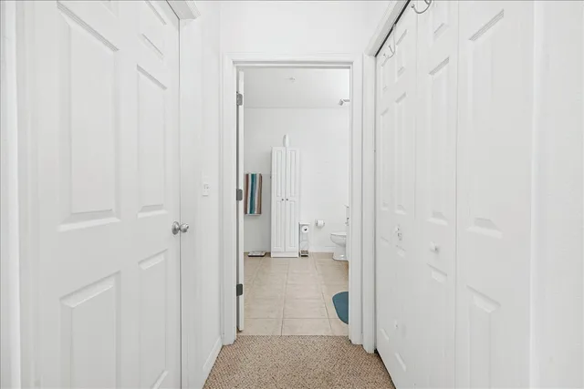 a spacious bathroom with a double vanity sink a mirror and a toilet