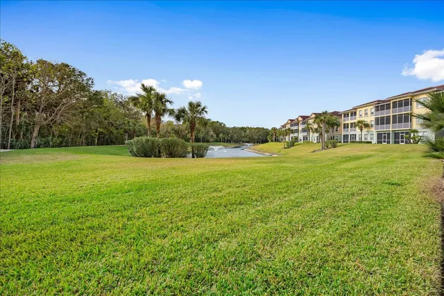 a view of a yard with a house in the background