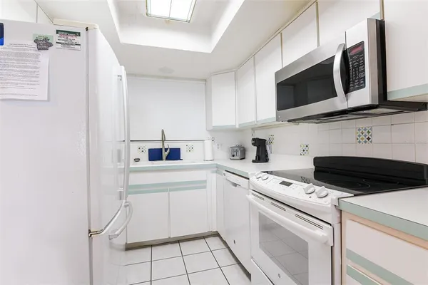 a bed sitting in a bedroom next to a window and dresser