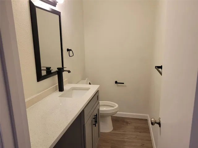 a bathroom with a sink a toilet and mirror