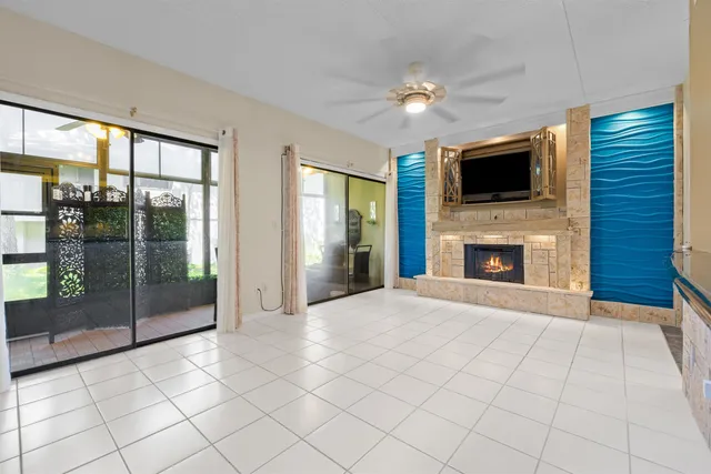 a view of an empty room with window and fireplace