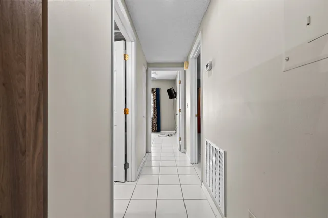 a view of a hallway view with wooden floor and staircase