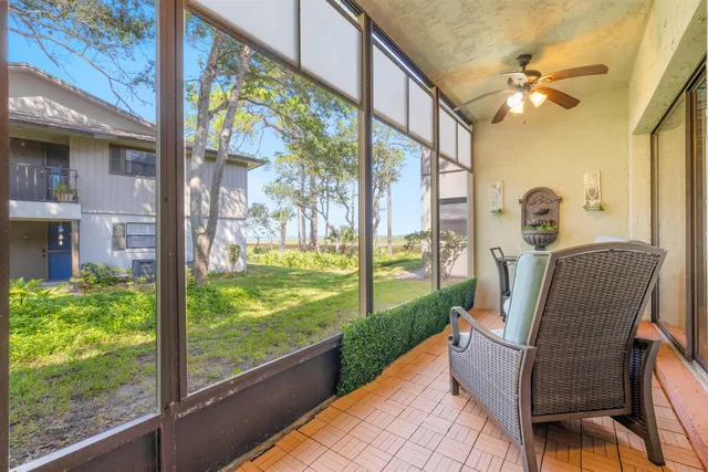a view of a porch with furniture and a yard