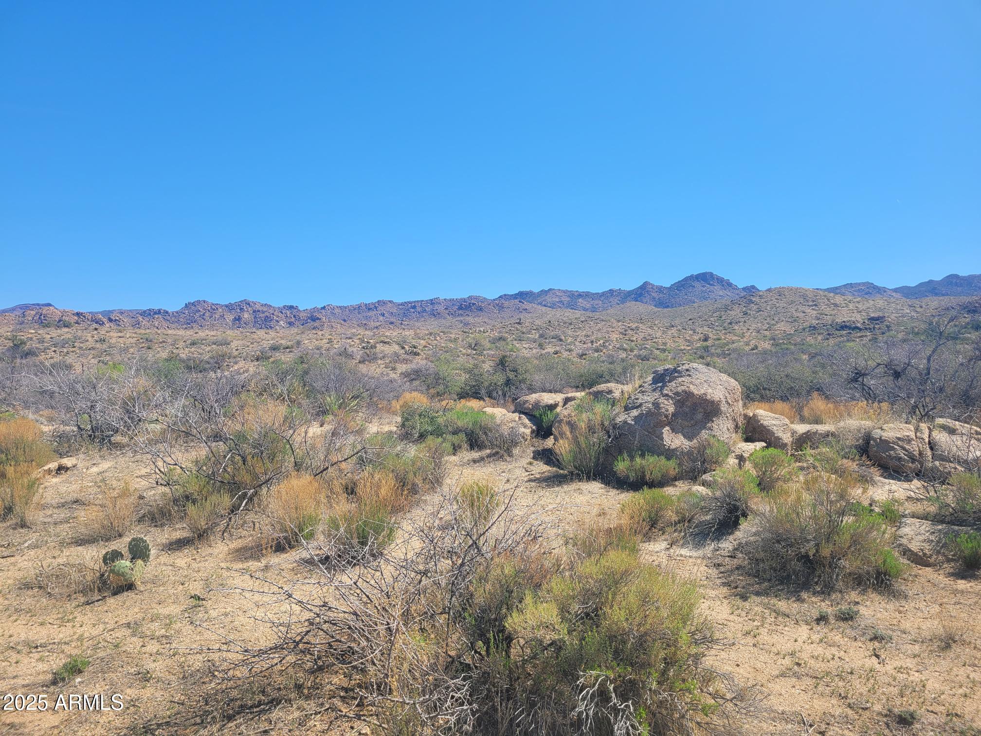 0 South Date Creek Road, Unit PARCEL H Congress, AZ 85332 - Photo 12 of 14 a view of a dry field with mountains in the background