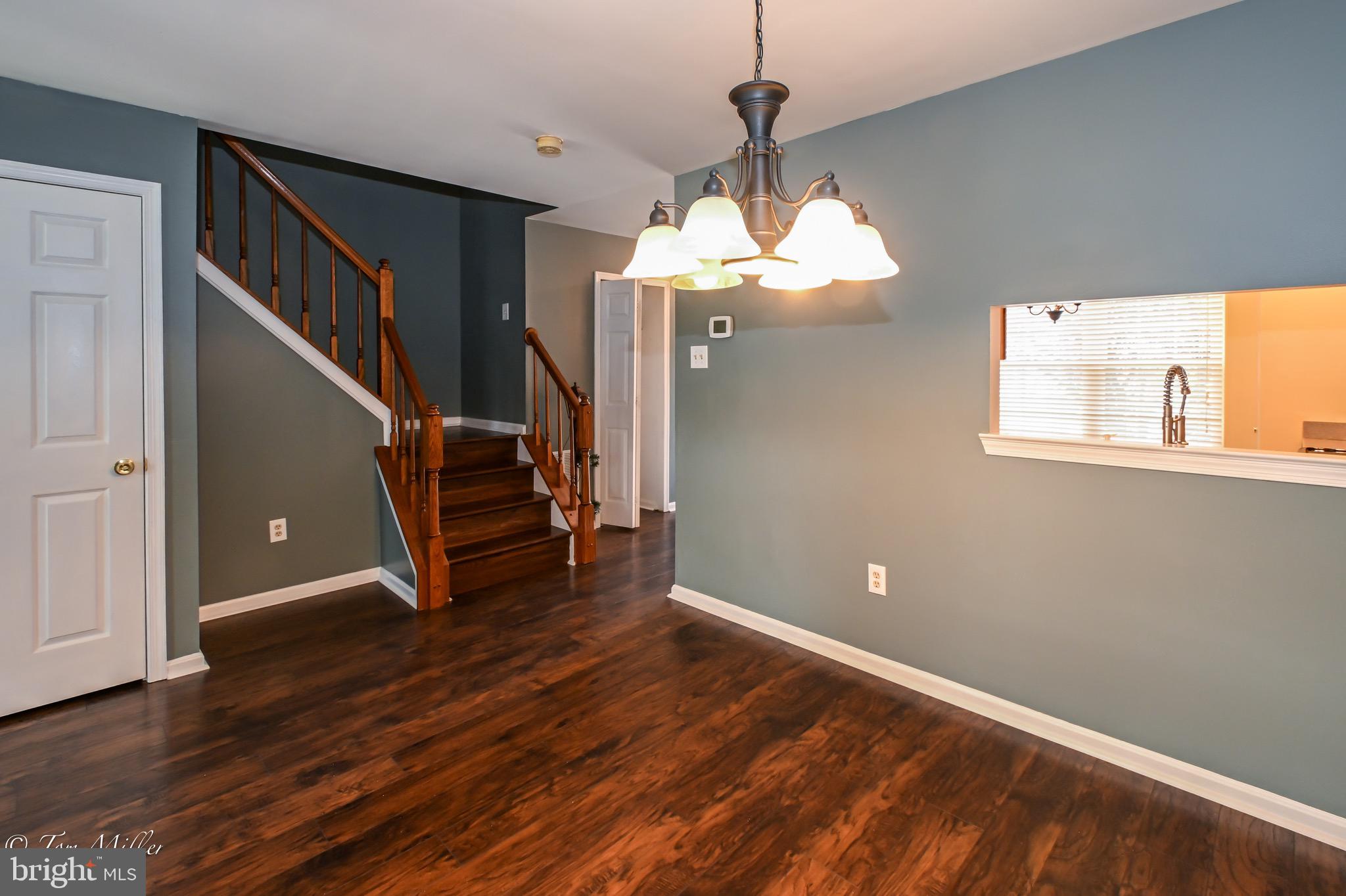 3721 Foxford Stream Road Nottingham, MD 21236 - Photo 19 of 48 a view of a room with wooden floor staircase and a chandelier