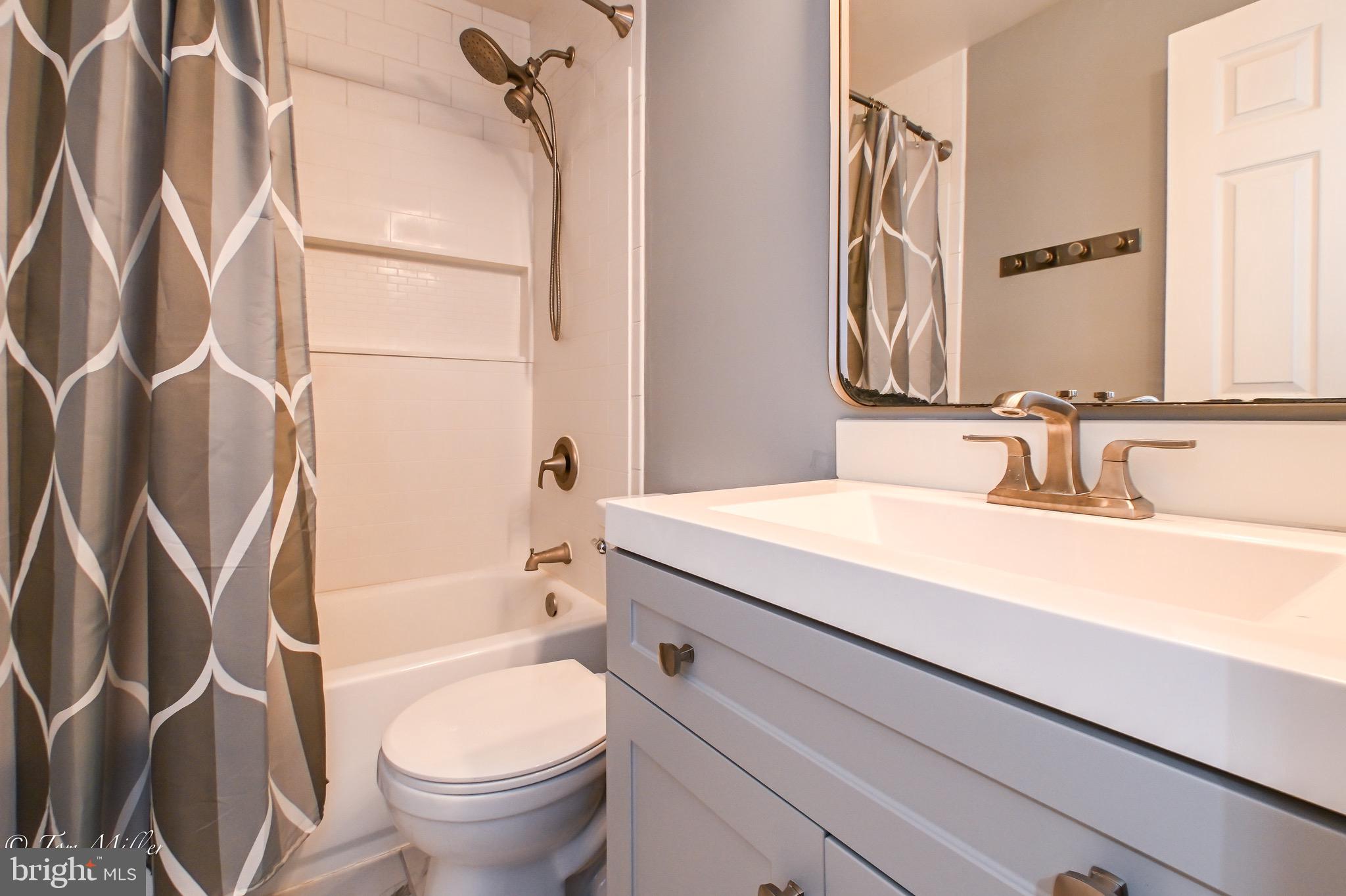 3721 Foxford Stream Road Nottingham, MD 21236 - Photo 26 of 48 a bathroom with a granite countertop sink a toilet and a mirror