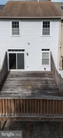 a view of a house with backyard porch and wooden floor