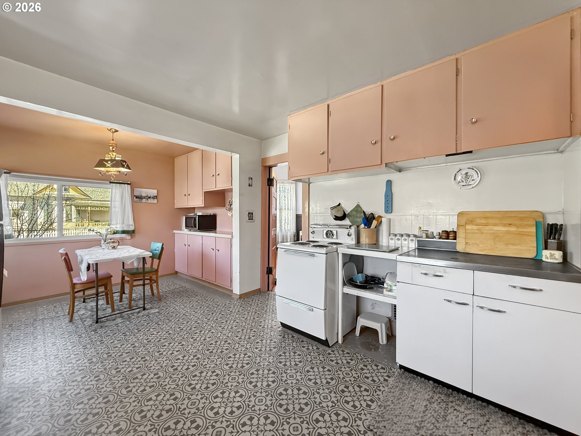 2291 2nd Street Baker City, OR 97814 - Photo 13 of 48 a kitchen with white cabinets and white appliances