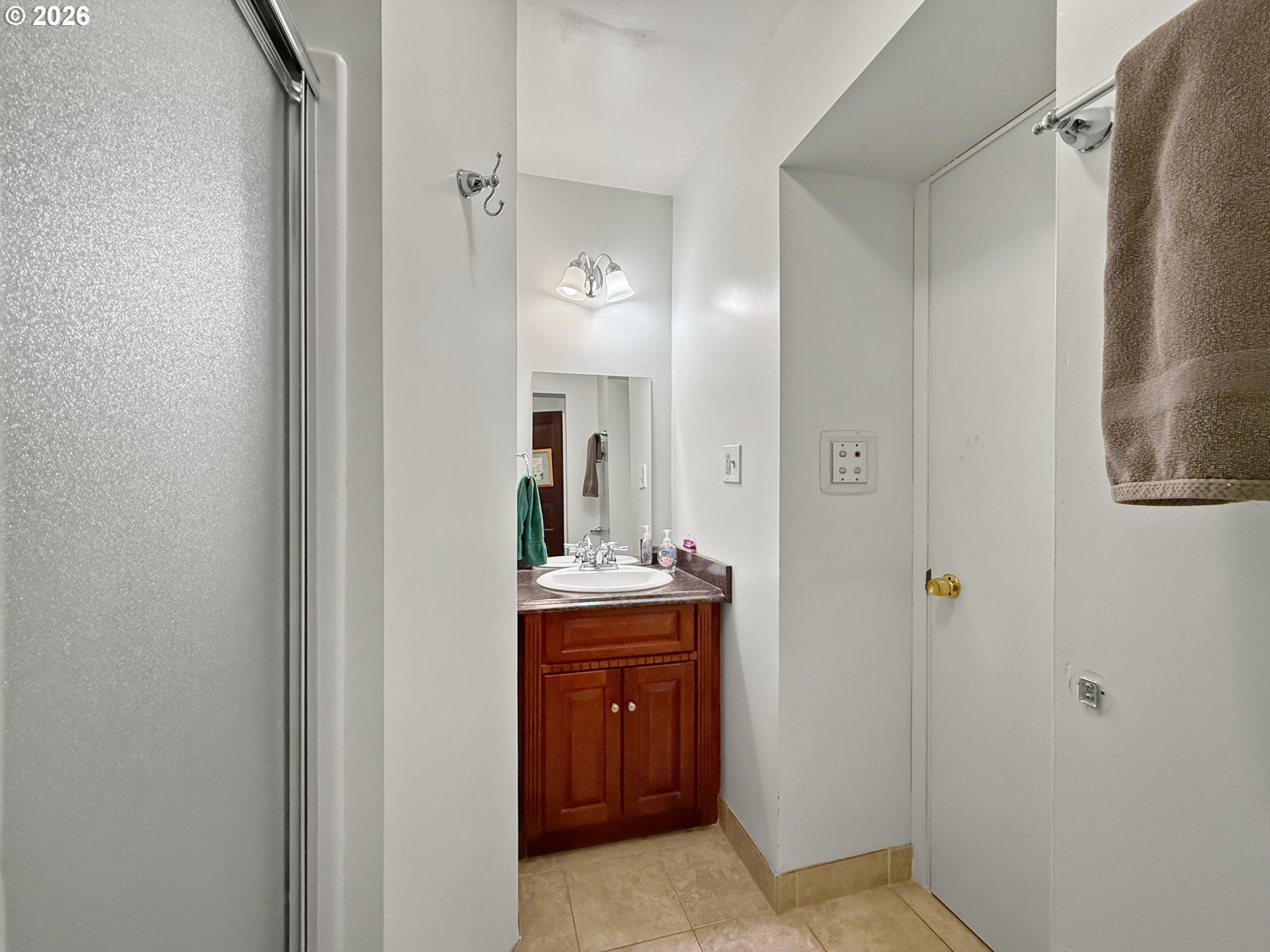 2291 2nd Street Baker City, OR 97814 - Photo 16 of 48 a en suite bathroom with a sink a mirror and a shower