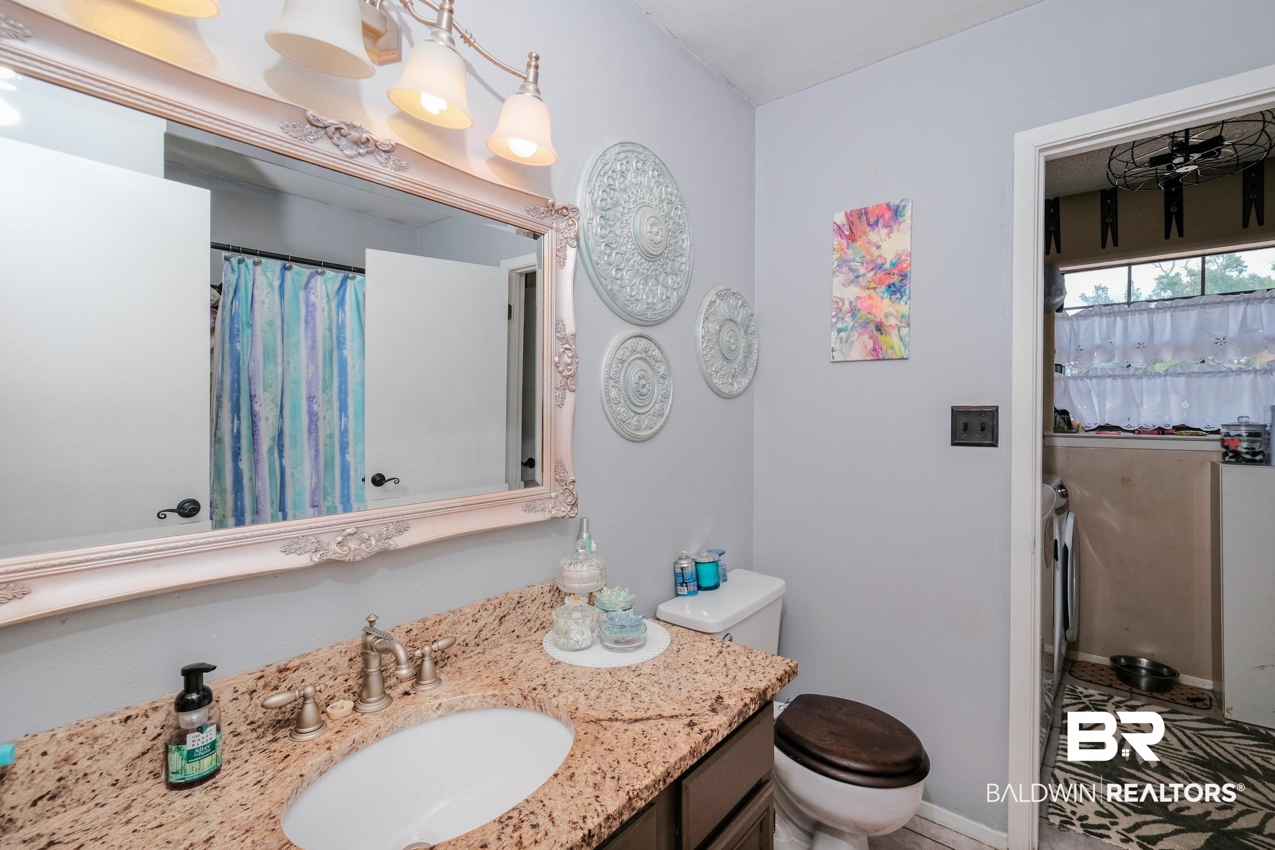 504 Ariel Avenue Foley, AL 36535 - Photo 24 of 33 Bathroom featuring tile patterned floors, toilet, and vanity