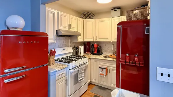 a kitchen with stainless steel appliances granite countertop a refrigerator stove and sink