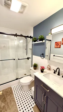 a bathroom with a sink a toilet and shower