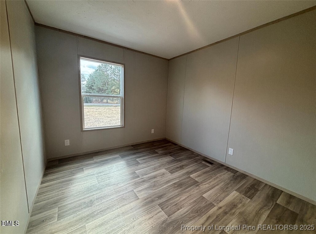 351 Page Road Godwin, NC 28344 - Photo 16 of 19 an empty room with wooden floor and windows