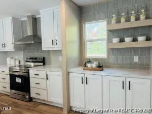 a kitchen with granite countertop white cabinets and window