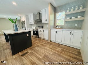 351 Page Road Godwin, NC 28344 - Photo 8 of 19 a kitchen with stainless steel appliances granite countertop a sink a stove and a refrigerator