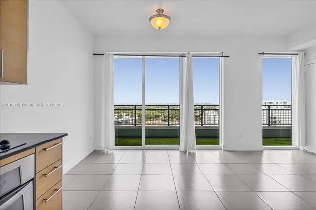 a view of an empty room with window and fireplace
