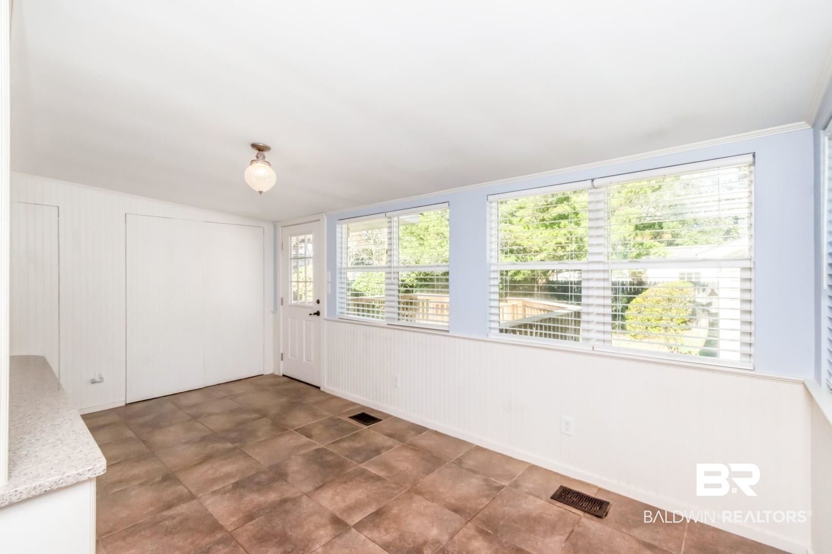 10 South Hathaway Road Mobile, AL 36608 - Photo 12 of 46 Unfurnished dining area featuring wooden walls and a decorative wall