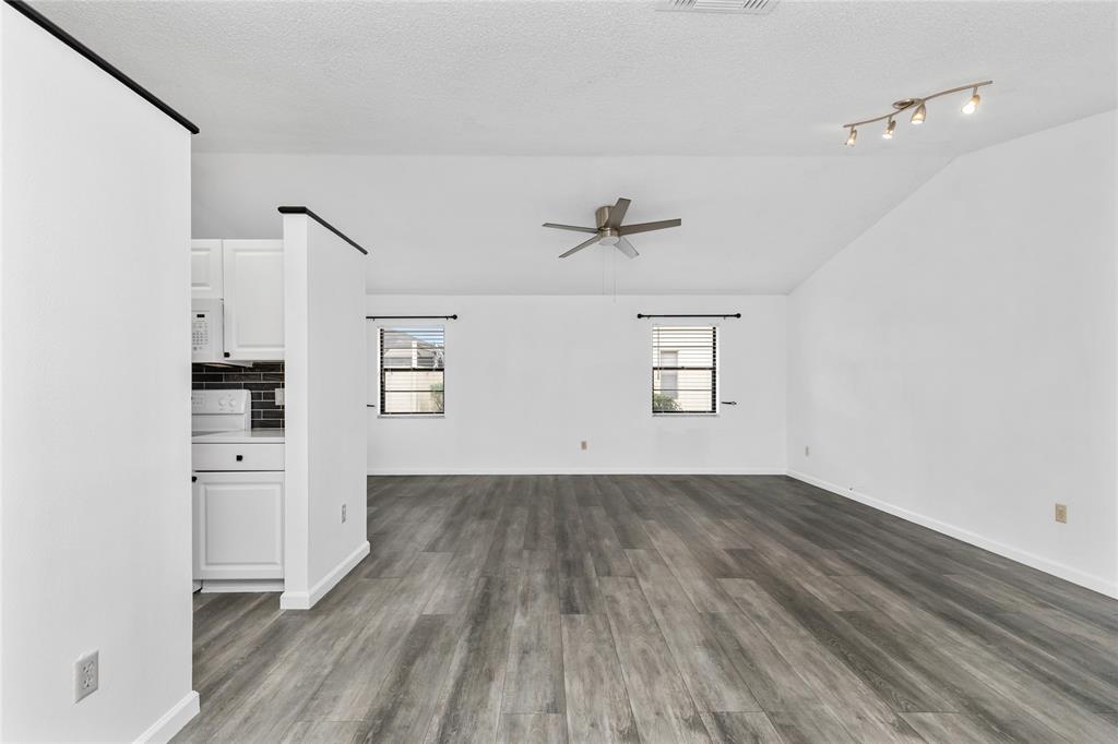 9114 Southwest 20th Street, Unit B Boca Raton, FL 33428 - Photo 12 of 36 a view of empty room with wooden floor and fan