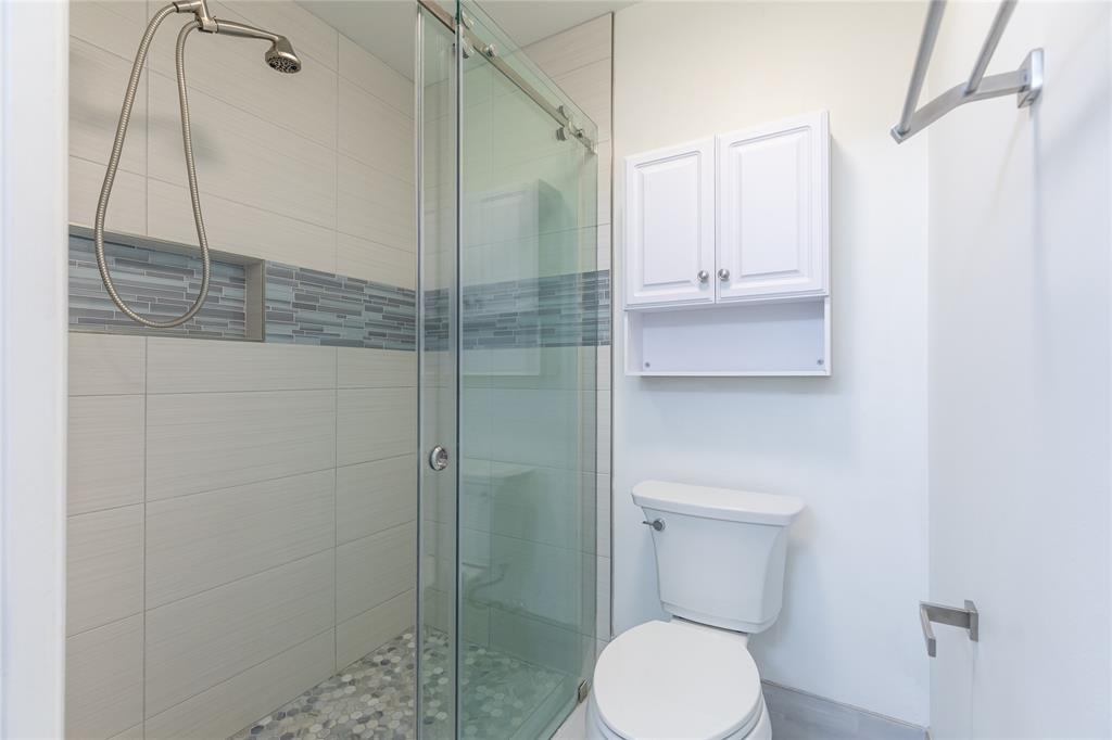 9114 Southwest 20th Street, Unit B Boca Raton, FL 33428 - Photo 22 of 36 a bathroom with a toilet and a shower