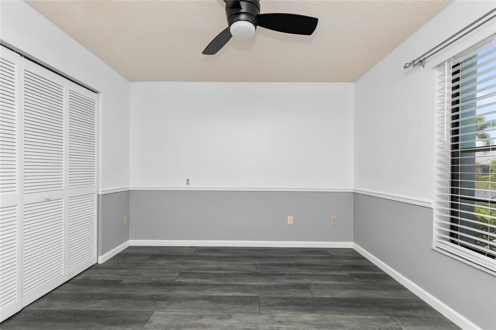 9114 Southwest 20th Street, Unit B Boca Raton, FL 33428 - Photo 24 of 36 a view of an empty room with wooden floor and a window