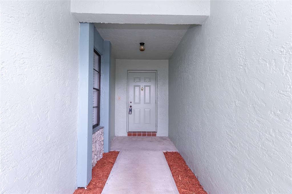 9114 Southwest 20th Street, Unit B Boca Raton, FL 33428 - Photo 4 of 36 a view of a hallway with wooden floor