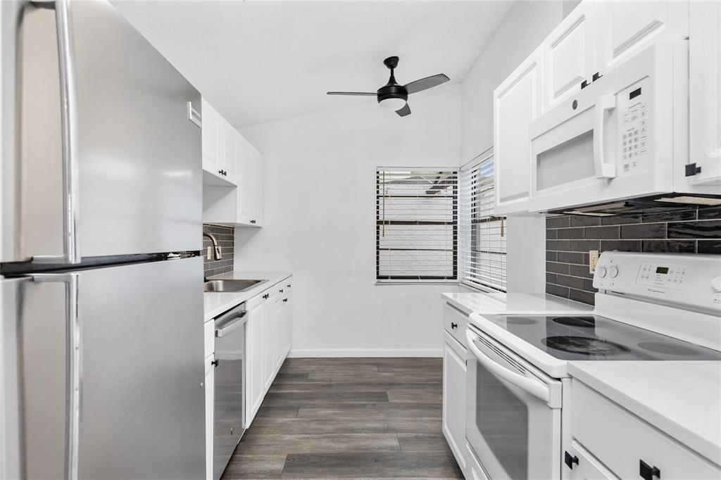 9114 Southwest 20th Street, Unit B Boca Raton, FL 33428 - Photo 6 of 36 a kitchen with cabinets and appliances