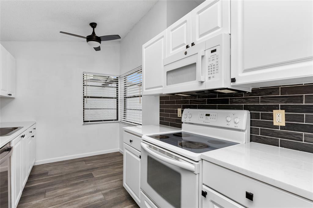 9114 Southwest 20th Street, Unit B Boca Raton, FL 33428 - Photo 7 of 36 a view of a kitchen with sink and wooden floor