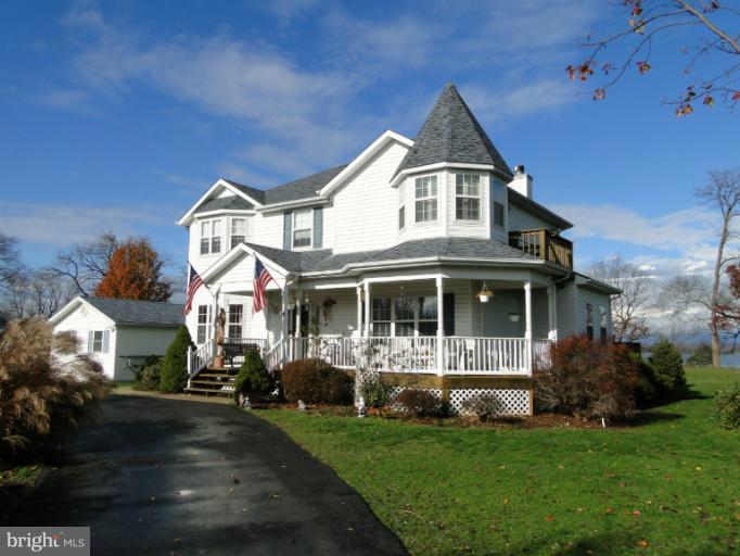 a front view of a house with a yard table and chairs