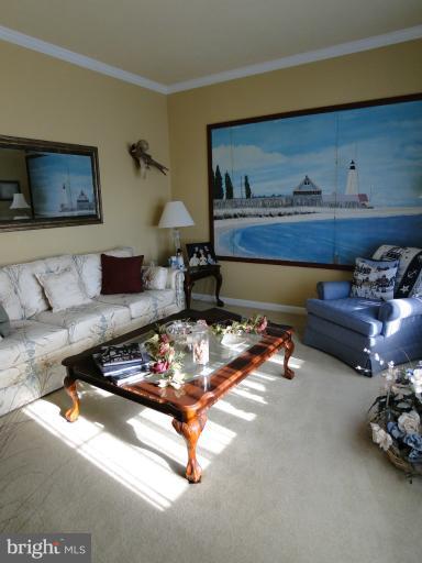 5979 Ketch Road Prince Frederick, MD 20678 - Photo 8 of 11 a living room with furniture and a lamp