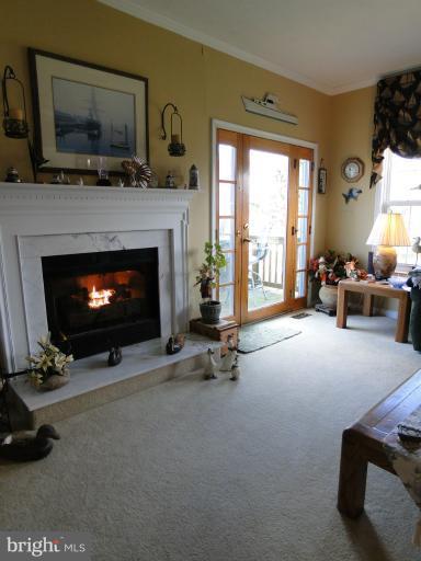 5979 Ketch Road Prince Frederick, MD 20678 - Photo 9 of 11 a living room with furniture a flat screen tv and a fireplace