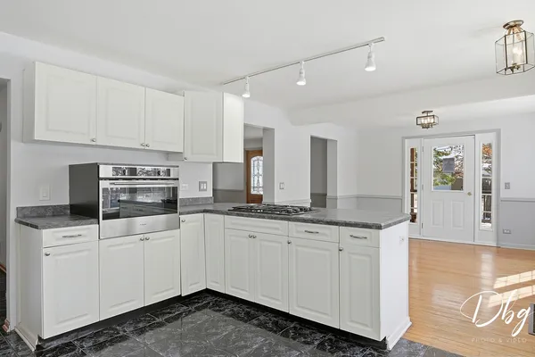 a kitchen with a sink and breakfast area