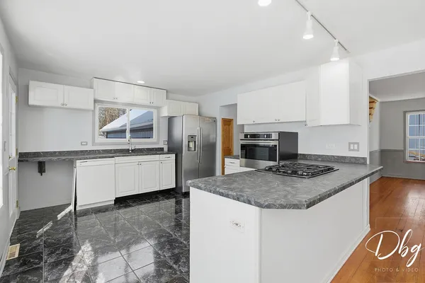 a kitchen with stainless steel appliances granite countertop a stove and a sink