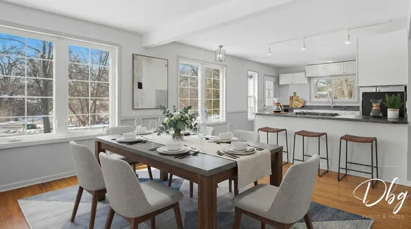 a living room with stainless steel appliances kitchen island a large counter and a refrigerator