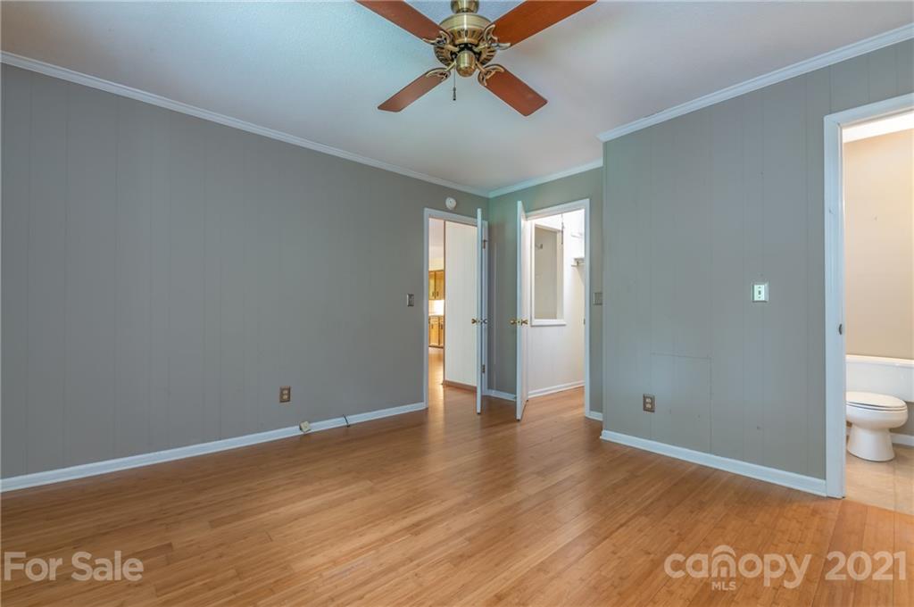 355 Winterset Trail Tryon, NC 28782 - Photo 12 of 22 an empty room with wooden floor and a ceiling fan