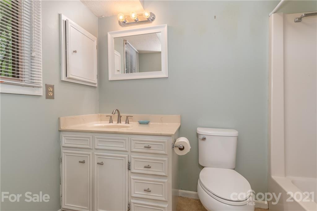 355 Winterset Trail Tryon, NC 28782 - Photo 16 of 22 a bathroom with a granite countertop toilet sink and mirror